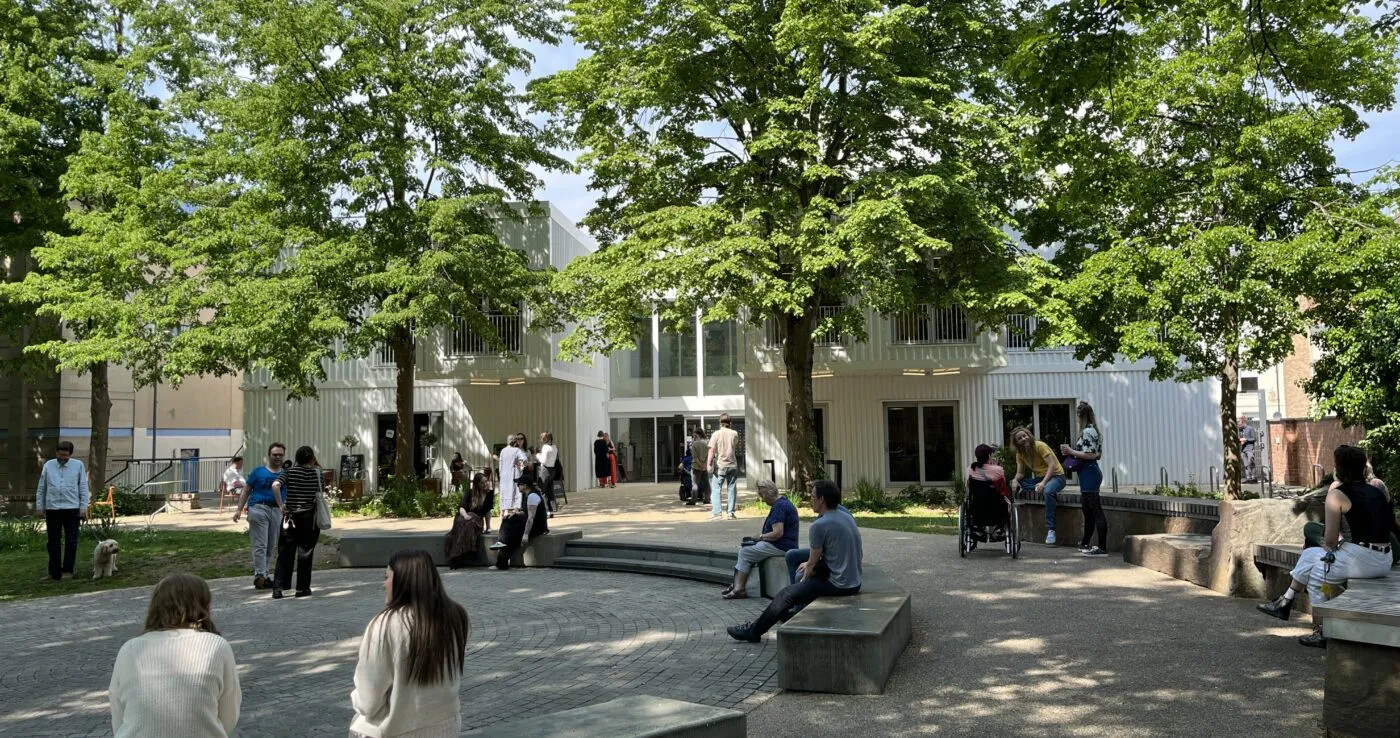 Outdoor seating area at a vibrant start-up coworking space with entrepreneurs working under trees